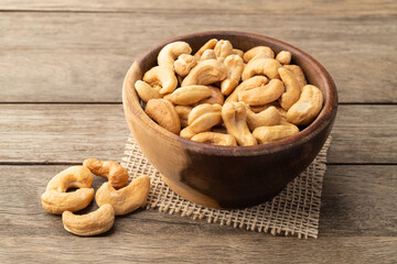 Cashew nuts in a bowl over wooden table