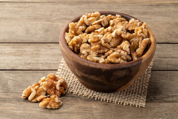 Walnuts in a bowl over wooden table