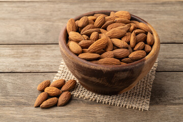 Almonds in a bowl over wooden table