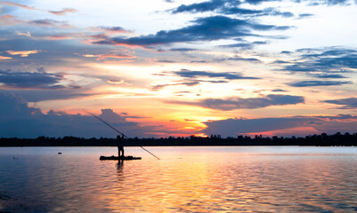 sunset over the river have fisherman silhouette