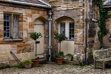 Fototapeta na wymiar sandstone buildings satding on cobbled courtyard