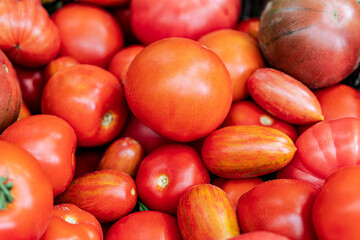 Background from natural fresh red tomatoes without additional processing. The concept of non-GMO natural products.