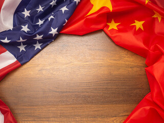 American and China flag on a wooden table with space for text. Top view. International relationship