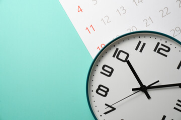 close up of calendar and clock on the green table background, planning for business meeting or travel planning concept