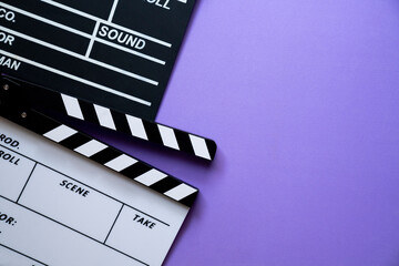 movie clapper on purple table background ; film, cinema and video photography concept