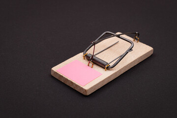 Blank Pink Sheet of Paper in Wooden Mousetrap - Template. Small Memo Paper in Mouse Trap on Black...