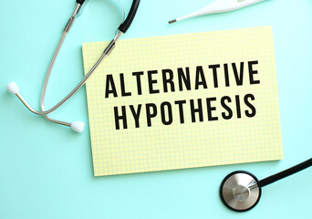 The text ALTERNATIVE HYPOTHESIS is written in a yellow pad that lies next to the stethoscope on a...