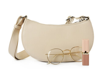 Stylish baguette bag with glasses and lipstick on white background