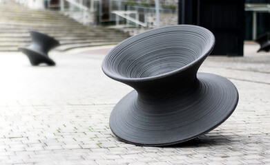 Fototapeta na wymiar Large grey spinner sculpture outside building