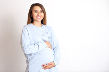 Portrait of a beautiful happy pregnant woman on a white background. The happiness of motherhood....