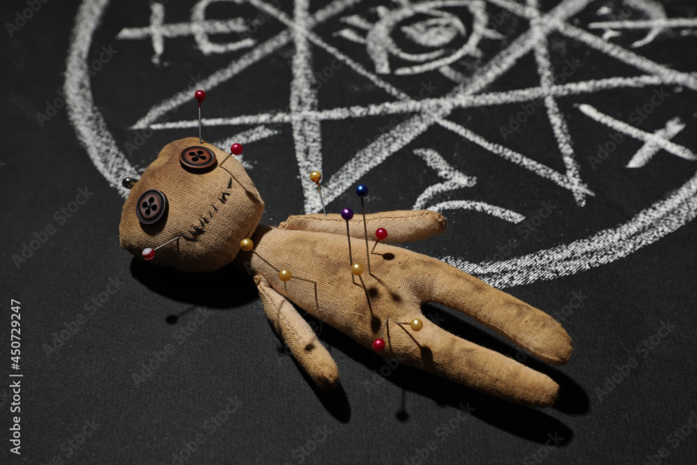 Wall mural voodoo doll near ritual circle drawn on black table