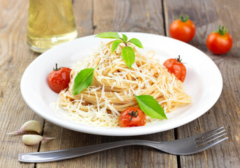 Pasta with tomato sause, cherry tomatoes and basil