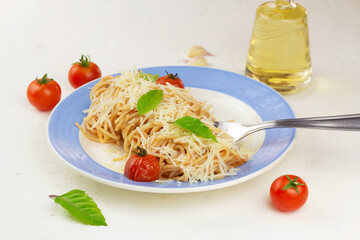 Pasta with tomato sause, cherry tomatoes and basil