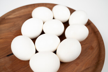 Close up of white eggs on wooden background. Organic eggs.