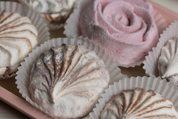 Homemade marshmallows of various colors and flavors. Lies on a tray. Close-up shot.
