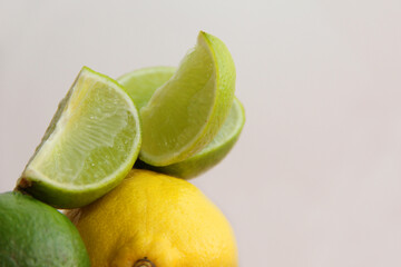 lime and lemon on a pink background.lime slices and lemon in the cut