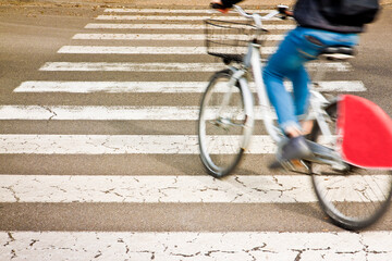 Bicycle riders on pedestrian crossing in motion blur