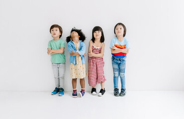 Ethnicity Diversity Group of kids with crossed arms looking up over gray background. Childhood, freedom, happiness, active lifestyle concept.