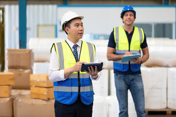 factory worker or engineer using tablet for preparing a job in warehouse storage