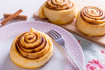 Sweet homemade cinnamon roll, bun with cinnamon powder