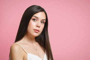 young woman brunette girl on a pink background