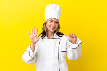 Young Russian chef girl isolated on yellow background counting six with fingers