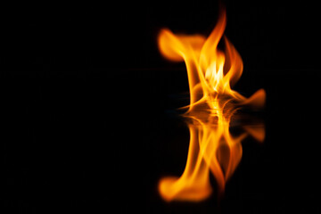fire flame with reflection in the glass on a black background