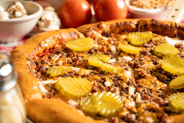 Pizza with beef and pickles close up