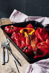 Roasted red and yellow peppers in baking tray.