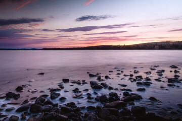 Purple and blue twilight over rocks Lily Bay, Moosehead Lake, Maine