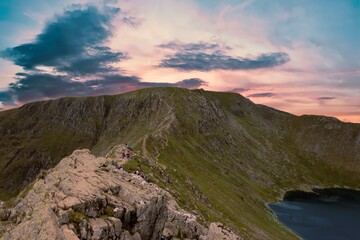 Fototapeta na wymiar Sunset over Helvellyn in the Lake District, with pink sky and dramatic clouds
