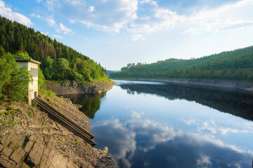 Fototapeta premium Panorama view of a dam in Germany in summer with blue sky an