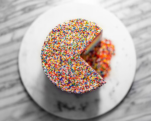 top view of sliced rainbow sprinkle cake