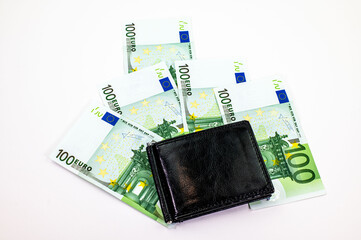 100 euro banknotes scattered on white background
