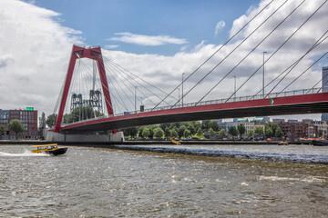 The Prince-Willem Alexander Bridge with the (in reality) remarkably red color. This bridge provides a riverbank connection between the Noordereiland and the center of Rotterdam.