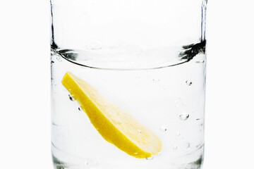 Fresh lemon slice in a transparent container with water