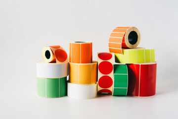Colored and white reels with self-adhesive labels for printers.