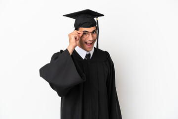 Young university graduate over isolated white background with glasses and surprised