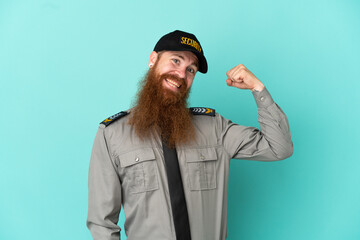 Redhead security man isolated on white background doing strong gesture