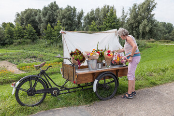 woman buyin flowers at flower stall
