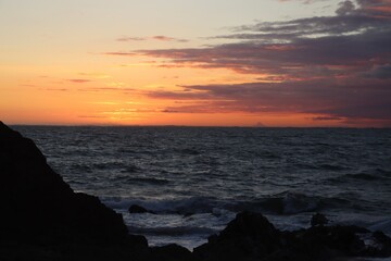 sunset over the rocks and sea 