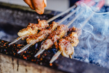 Grilling lamb kebabs on the barbecue