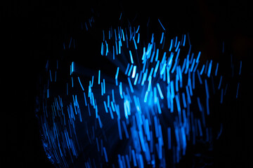 Blue abstract particles and lines with bokeh and blur in dark background.