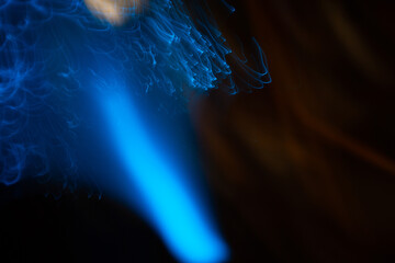 Blue abstract particles and lines with bokeh and blur in dark background.