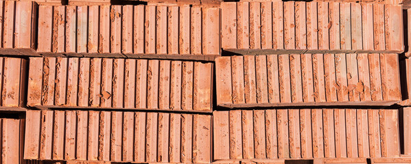 Side view of red bricks stacked in a row