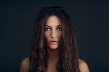 Fototapeta premium Portrait of beautiful young brunette woman with healthy hair.