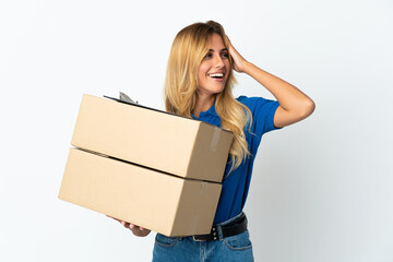 Young blonde Uruguayan delivery woman isolated on white background smiling a lot