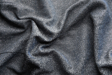 Fototapeta premium Fabric evening black dress girl with sequins, rhinestones. colorful sequined texture
