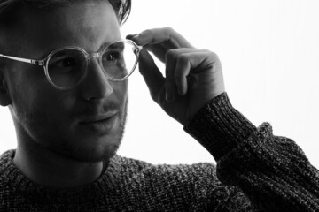 Male in glasses with futuristic holographic interface to display data. Portrait of beautiful young man. Augmented reality, future technology, internet concept.