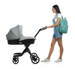 Happy young woman with baby stroller on white background